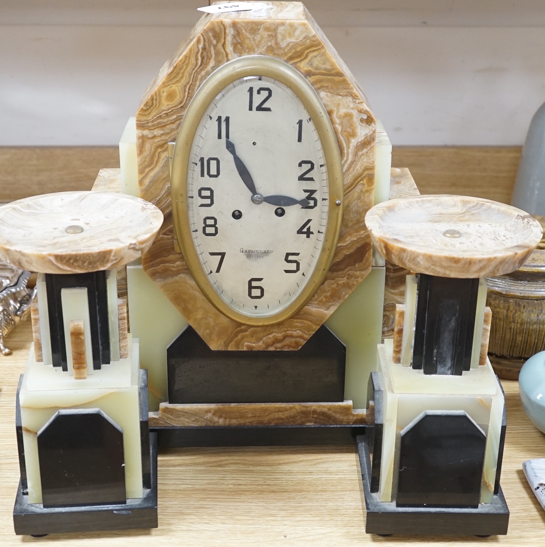 An Art Deco onyx and marble clock garniture, clock 42cms high